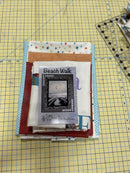 All of the fabric included in the Alphabet Panel Kit nicely folded with the pattern for the kit on top. 