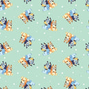 A repeating cartoon fabric design with the characters Bluey and Bingo tossed on a light aqua background. 
