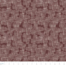 Brown and white geometric patterned fabric with a ruler at the bottom for scale.