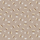 Fabric patterned with tossed espresso martinis on a taupe background. 