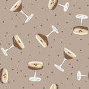 Fabric patterned with tossed espresso martinis and brown dots on a taupe background. 