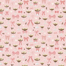 Fabric patterned with espresso martinis, pink bows, hearts, and coffee beans on a light pink background. 