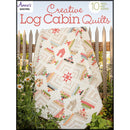 The front cover of Annie's Quilting Creative Log Cabin Quilts book, featuring a colorful sample quilt draped over a fence
