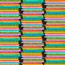 Stacks of books with colorful spines arranged in a pattern on a black background.