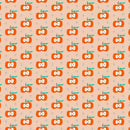 Fabric patterned with stylized red cartoon apples with green leaves on a pink background. 