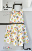 The front cover of the Farmhouse Apron Pattern featuring a completed sample with bright colorful fabric