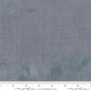 A close up swatch of the Moda grunge basic in the color smoke. The fabric is a soft tonal print with a medium gray tone with small blends of darker cool gray. 