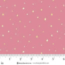 Pink fabric with small yellow star patterns and a ruler at the bottom for scale.