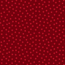 A close-up of a red fabric or material swatch with an allover pattern of smaller pink polka dots.