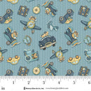 Fabric with vintage vehicle pattern on a blue background, measured against a ruler.