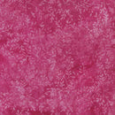 A close-up of a pink batik fabric featuring a light pink leafy vine pattern.
