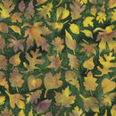 A batik fabric patterned with various yellow fall leaves on a dark green background. The background has a soft pattern reminiscent of water color paint. 