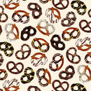 Fabric with a repeating pattern of tossed chocolate pretzels on a cream background.