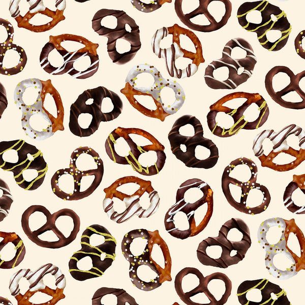 Fabric with a repeating pattern of tossed chocolate pretzels on a cream background.