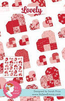 Lovely Quilt Pattern From It's Sew Emma. It shows a sample quilt in red, pink, and white. 