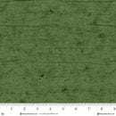 Textured green fabric with a ruler at the bottom for scale