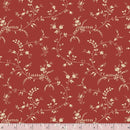 Red fabric with a repeating beige floral vine pattern, shown flat with a ruler along the bottom edge for scale.