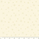 A fabric swatch featuring delicate beige snowflakes tossed on a warm cream background. There is a ruler at the bottom for scale. 