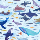 Pattern of whales, fish, and seals on a blue background