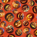 Tossed spooky jack o lanterns on an orange background