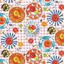 Colorful pattern of plates, tomatoes, and olives on a red checkered background