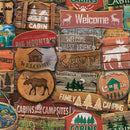 Collection of wooden signs with camping and nature-themed designs.