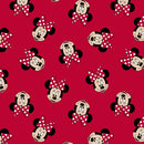 Tossed Mini Mouse faces in her signature design with red and white polka dots tossed on a bright red background. 