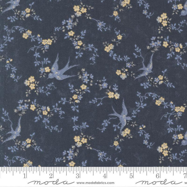 Floral and bird patterned fabric with a ruler at the bottom
