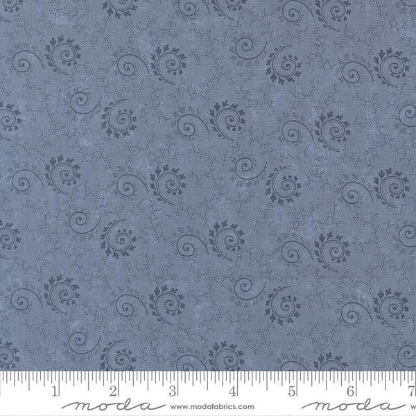 Blue fabric pattern with black swirls and floral designs, featuring a ruler for scale.