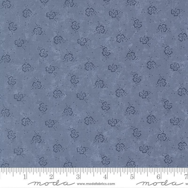 Blue fabric with floral pattern and ruler for scale