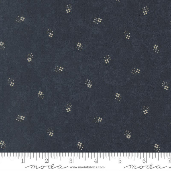 Navy fabric with small white floral pattern and Moda label at the bottom.