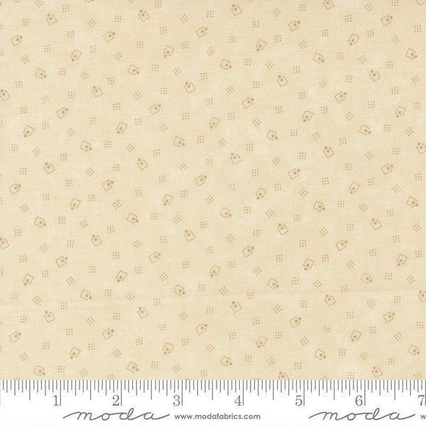 Beige fabric with small pattern and Moda label at the bottom