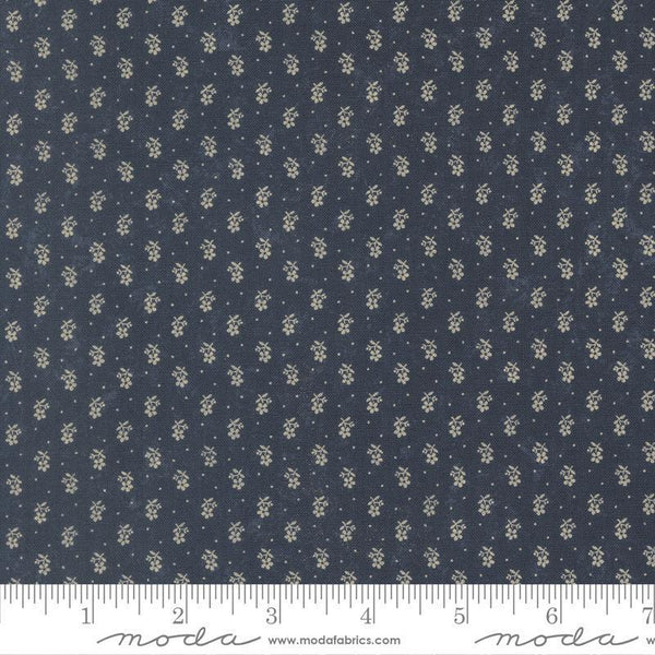 Navy fabric with small white floral pattern and Moda label at the bottom.