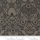 Fabric swatch featuring dark gray beehives, bees, sunflowers, and leaves, on a black background with a moda ruler for scale. 