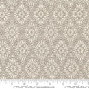 Complex geometric gray fabric swatch with a Moda branded ruler for scale