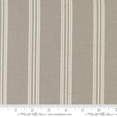 Striped gray and white fabric with a moda branded ruler for scale