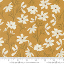 Floral fabric with white flowers on a yellow background with a moda branded ruler for scale