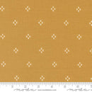 Golden Brown fabric with white star pattern and Moda label
