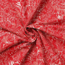 Red fabric with white printed patterns on a red background