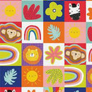 Colorful fabric patterned with rainbows, animal faces, and flowers on a block background. The background alternates between bright colors and white. 