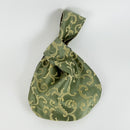 An example of a completed Japanese knot bag using the kit available in this class. The material is a lovely shade of green with cream details 