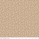 Floral patterned fabric with small flowers on a beige background and a ruler for scale