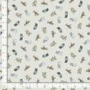 Fabric with small animal pattern on a light background, measured against a ruler.