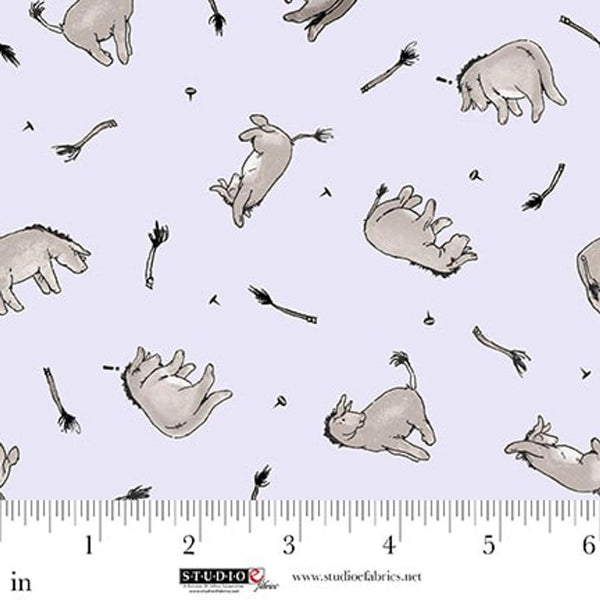 Fabric with cartoonish animal illustrations on a light blue background, featuring a ruler for scale.