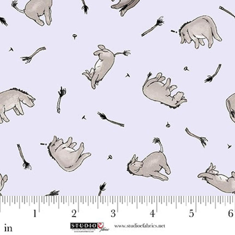 Fabric with cartoonish animal illustrations on a light blue background, featuring a ruler for scale.