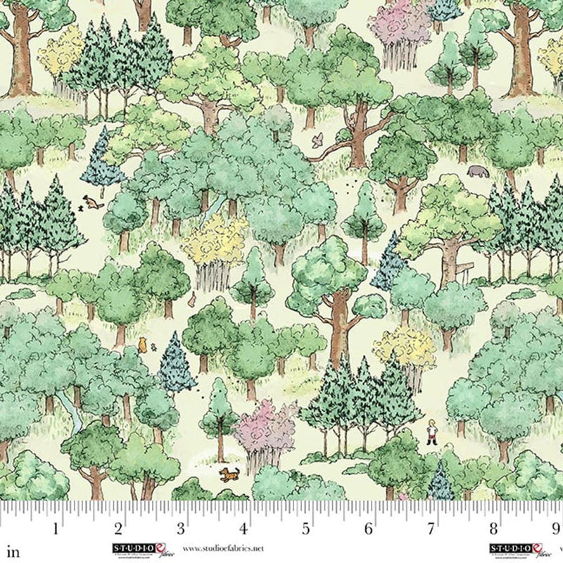 Pattern of trees and animals on fabric with a ruler for scale.