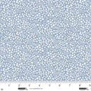 Fabric with small white floral pattern on a light blue background, with a ruler at the bottom.