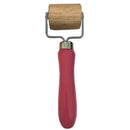 Pink roller with wooden handle on a white background