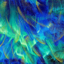 Fabric swatch featuring a multicolored blue and teal aurora with metallic gold accents. 