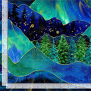 A colorful abstract fabric print featuring vignettes of the night sky, auroras, and evergreen forest in green, blue, and navy with metallic gold accents separated by bands of gold. There is a ruler along the left and bottom edge for scale. 